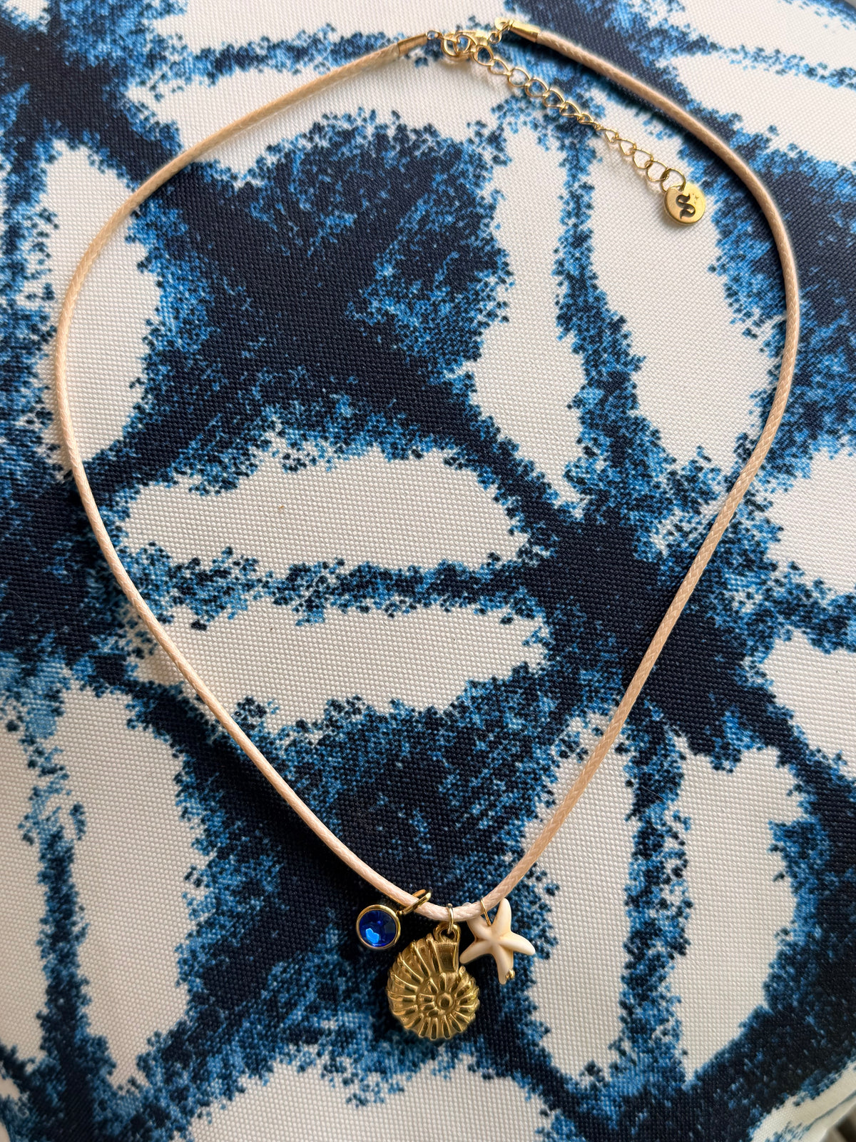 Gold chain necklace featuring delicate sea shell charms, ocean inspired summer jewelry by Shop Showy.
