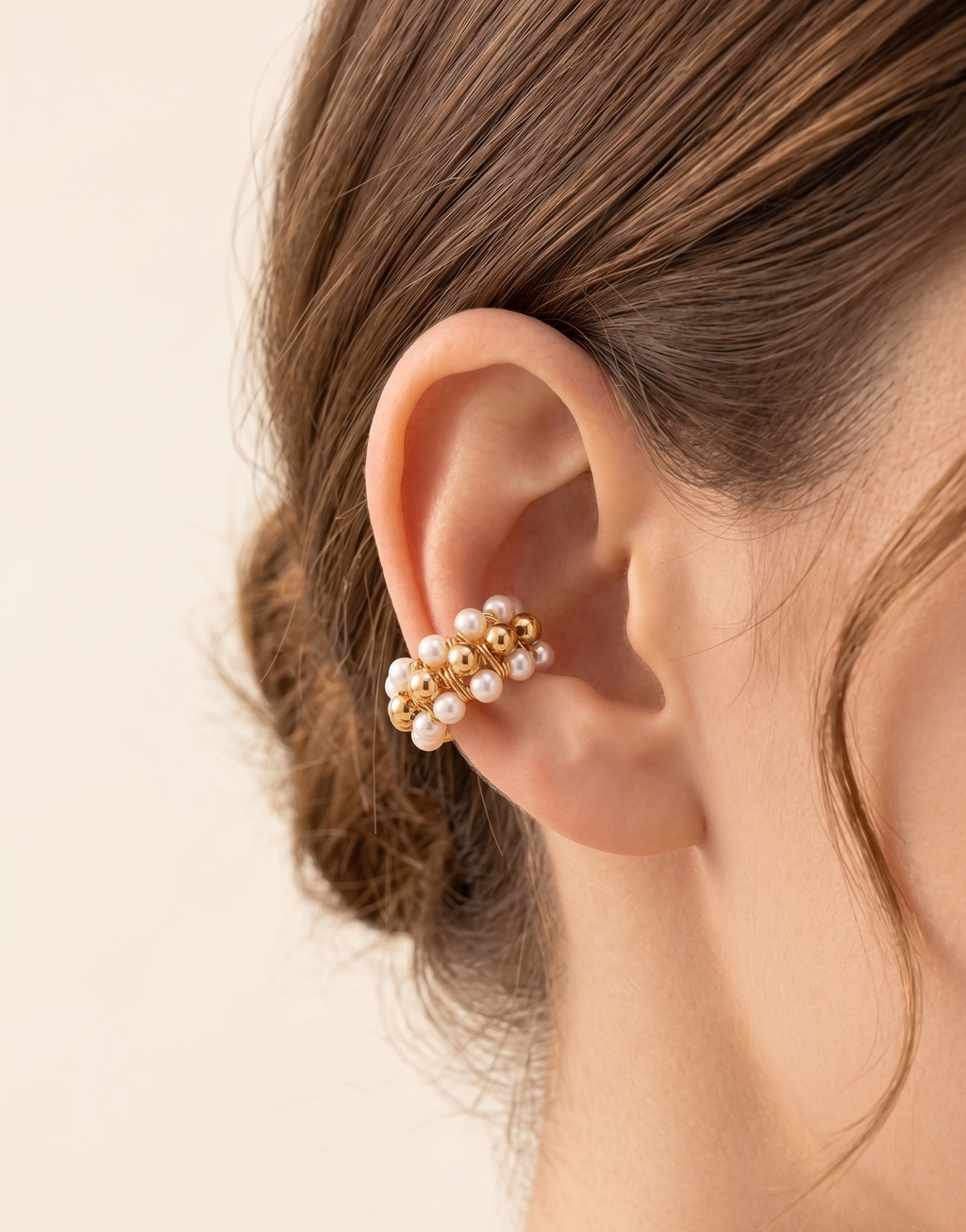 a model wearing a beaded earcuff