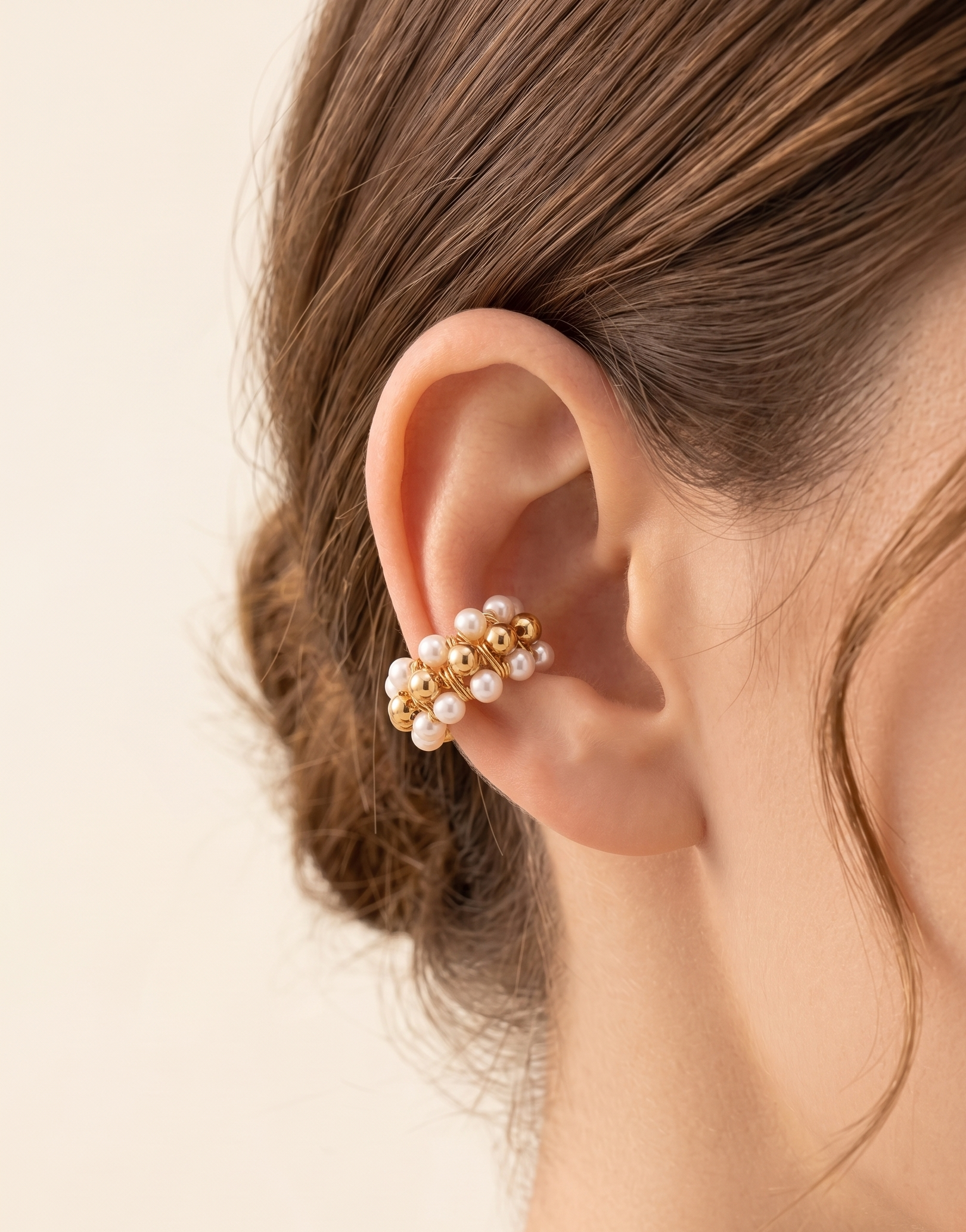 a model wearing a beaded earcuff