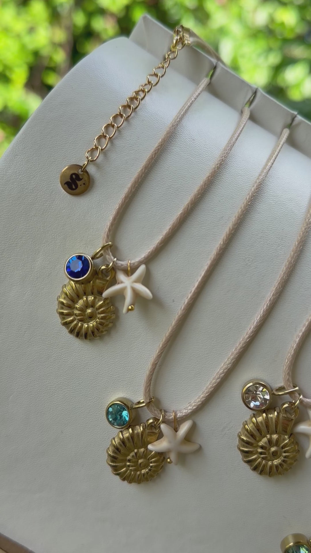 Gold chain necklace featuring delicate sea shell charms, ocean inspired summer jewelry by Shop Showy.